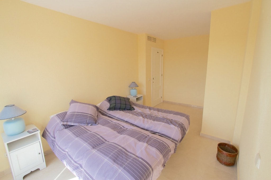 Bedroom 4 with double bed and yellow walls
