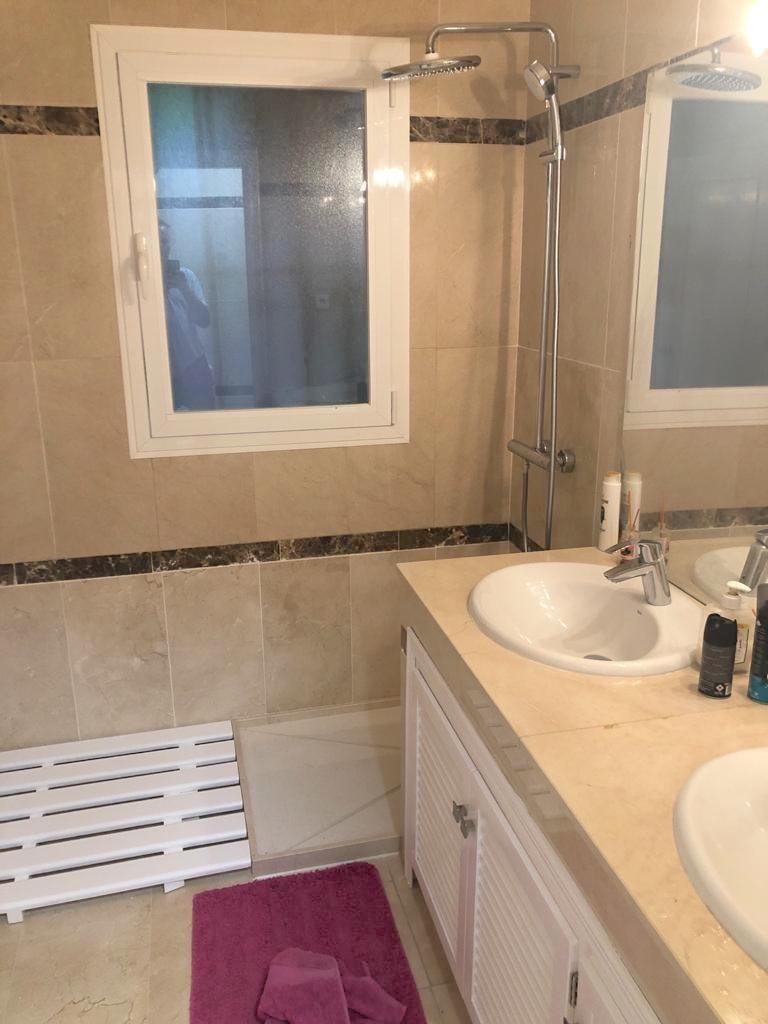 Bathroom with walk-in shower and marble tiles