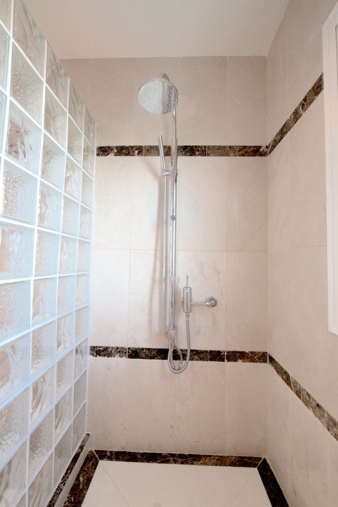 Shower with marble trim and glass block wall
