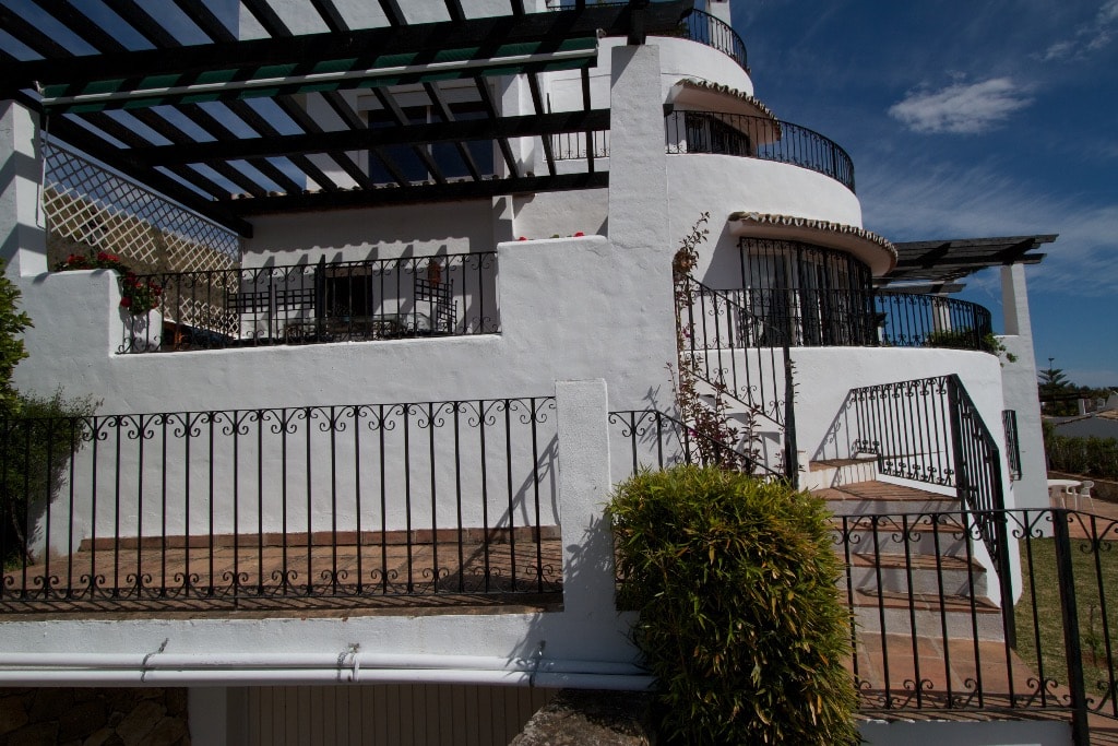 Club Sierra exterior with curved balconies, pergolas and blue sky