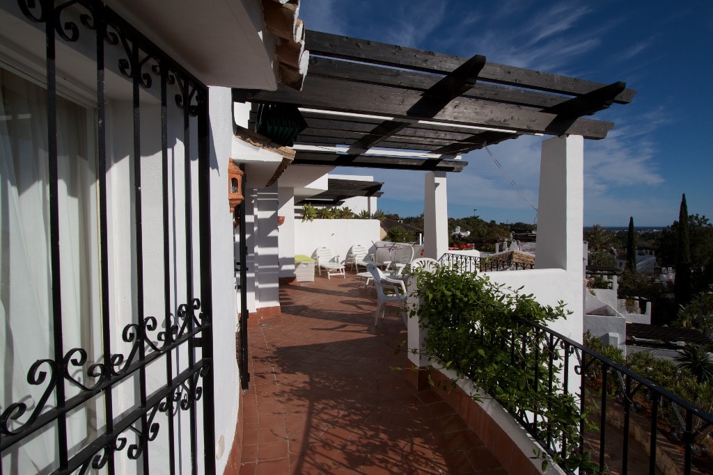 Pool terrace with parasols and sea views